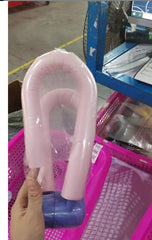 Pink and blue plastic toy held by a hand in a store setting