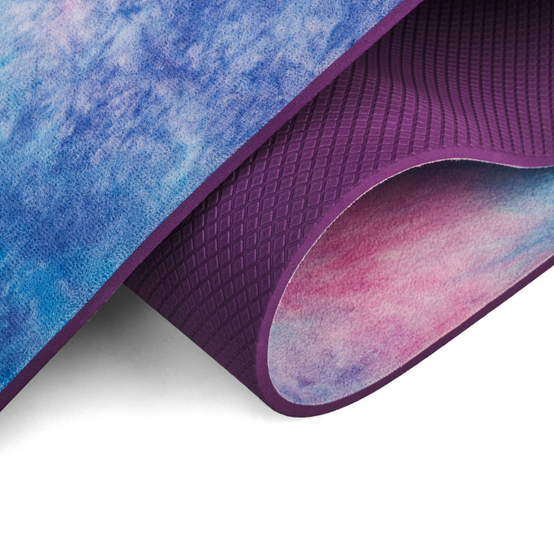 Close-up of a blue and purple yoga mat with watercolor design