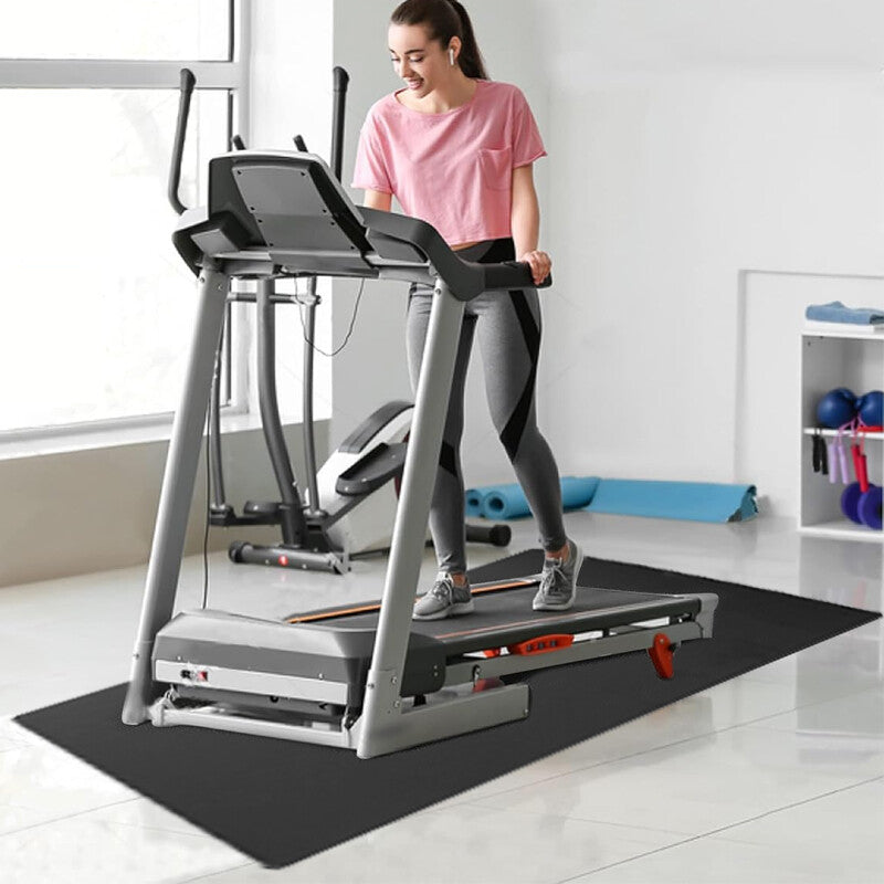 Woman using a treadmill in a home gym setting