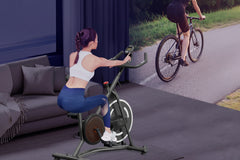 Woman exercising on a stationary bike in a home setting with text 'Real Comfortable Riding Feeling'.